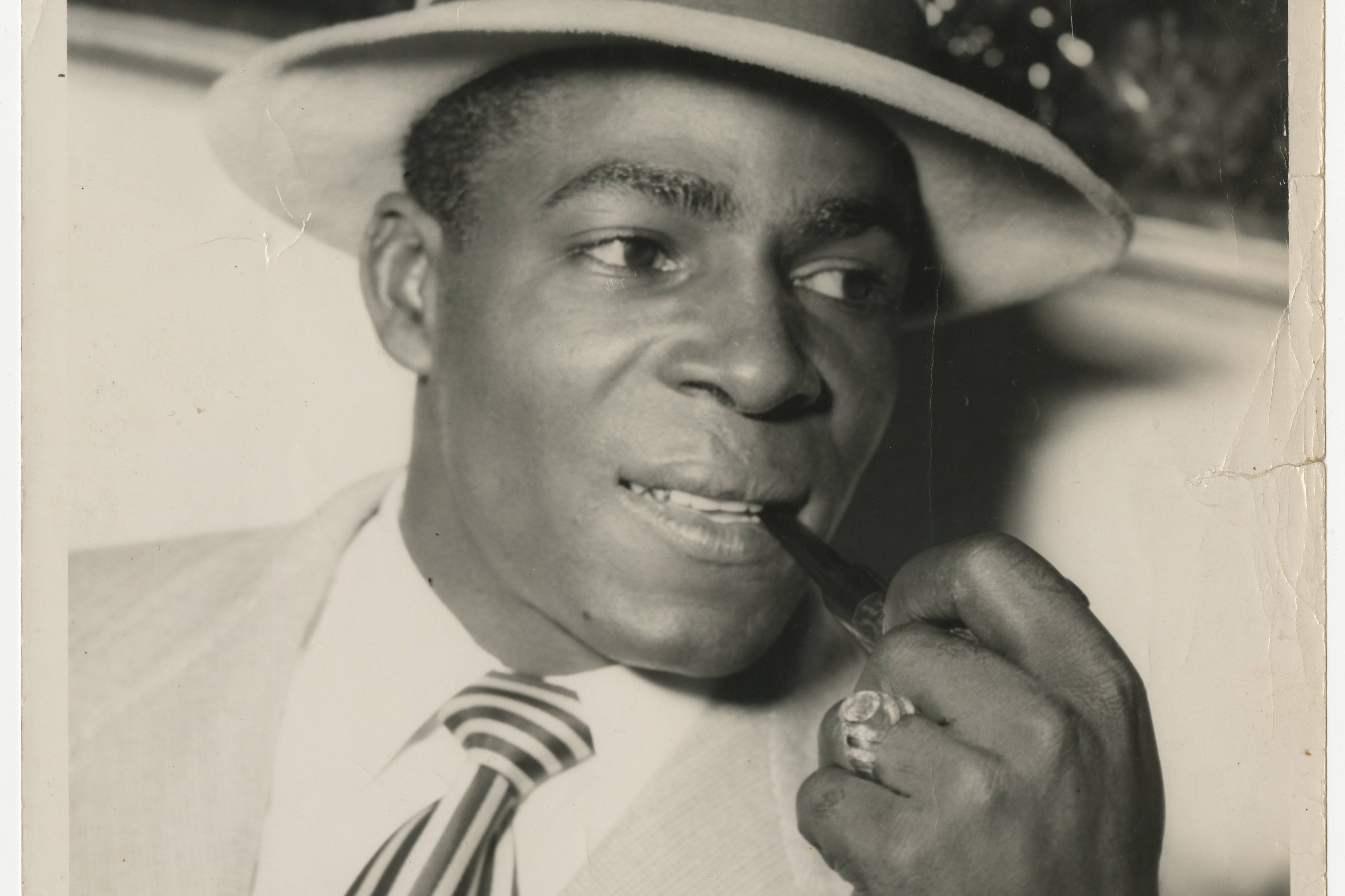 Man in suit smoking a pipe, undated. Cuban Photograph Collection. Cuban Heritage Collection, University of Miami Libraries.